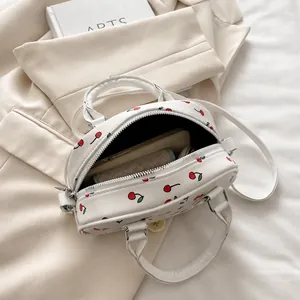 Interior view of white cherry print handbag showing storage capacity for essentials