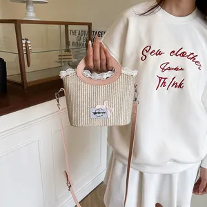 Chic summer straw handbag with pink leather handles and lace bow detail for women