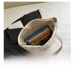 Top view of large tote bag showing interior capacity with books and tablet inside