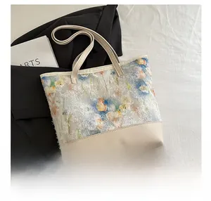Close-up of tote bag with floral 3D embroidery lace and premium beige leather detail