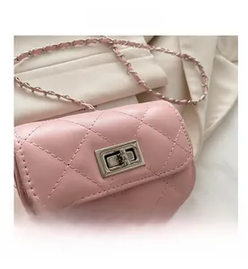 Close-up of pink quilted mini bag showing leather texture and silver rotating lock