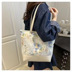 Detail of artistic floral pattern with 3D texture on large white tote shoulder bag