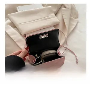 Detailed interior view of pink quilted crossbody bag holding lipstick and cosmetics
