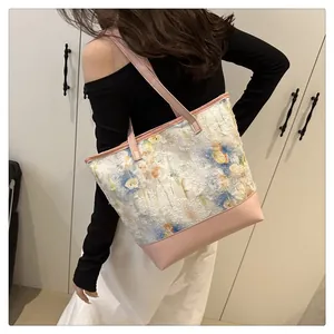 Detail of pink leather tote bag with floral embroidery and spacious shoulder strap