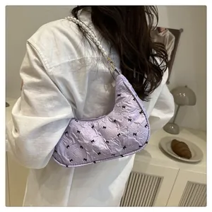Lavender bubble quilt bag with black bow prints and elegant pearl shoulder strap