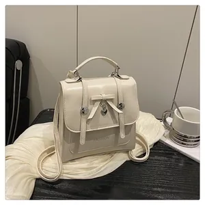 Creamy white PU leather backpack with bow decoration and heart pendant for school girls