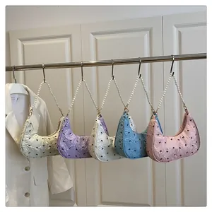 Detailed view of crescent handbags with black bows and pearl handles in five pastel colors