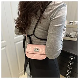Close-up of pink quilted leather mini crossbody bag with silver turn-lock and chain strap