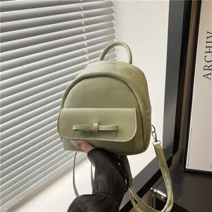 Mini green faux leather backpack with bow detail and adjustable straps for women
