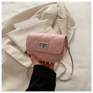 Detail of pink quilted leather bag with silver twist lock and chain shoulder strap
