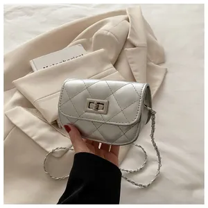 Detail of silver quilted mini crossbody bag with metal chain strap and twist lock