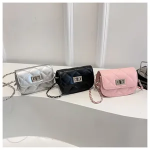 Detailed row of mini quilted chain bags in silver black and pink with metal locks