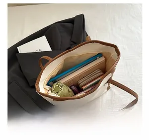 Spacious tote bag showing interior storage for laptop, umbrella, wallet and notebooks