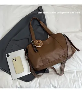 Brown faux leather tote bag size comparison with iPad and mobile phone display