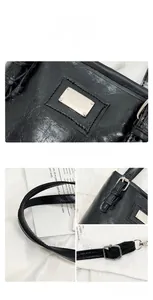 Detail view of retro black oil wax leather bucket bag with silver hardware and stitching