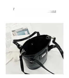 Top view of spacious interior with magnetic closure on black bucket bag