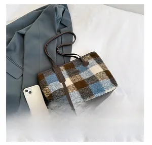 Detailed view of plaid wool tote bag with soft mohair texture and leather shoulder straps