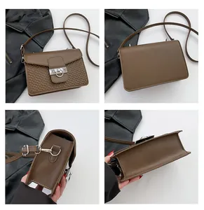 Detail view of brown retro small square bag with embossed texture and silver ring buckle