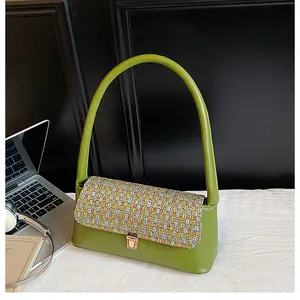 Detail of avocado green leather shoulder bag with tweed flap and golden metal clasp