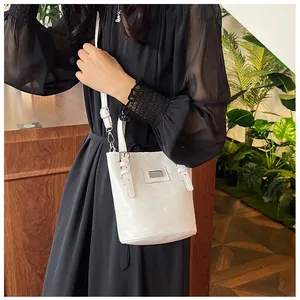 Ivory oil wax leather bucket bag with adjustable strap and silver metal plaque detail
