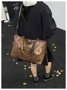 Close-up of brown large tote bag with retro texture and cute donut charm accessory