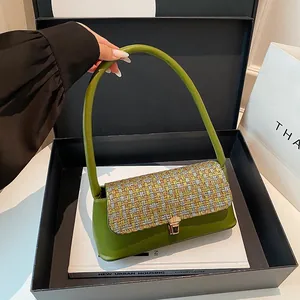 Minimalist green leather and tweed baguette shoulder bag with golden buckle closure