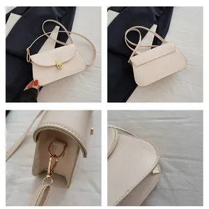 Détails du sac selle crème avec fermoir rotatif doré et texture en cuir élégante