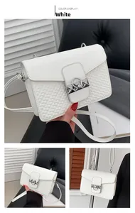 Detail of white PU leather crossbody bag with heart-quilted pattern and metal ring buckle