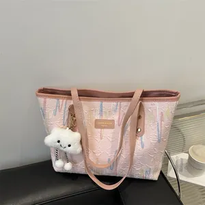 Pink jacquard tote bag with colorful stripes and a white cloud plush charm for women
