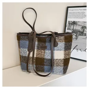 Detailed view of the vintage plaid wool tote bag with soft texture and leather handle