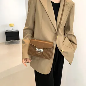 Vintage caramel brown crossbody bag with textured wave pattern and silver buckle hardware