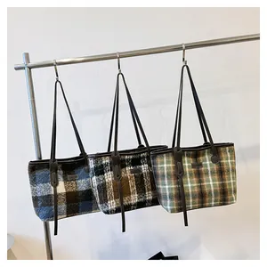 Detailed comparison of three plaid wool tote bags in blue, black, and green colors