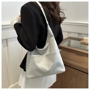 Seitenansicht einer grauen großen Tragetasche am Modell in minimalistischer Umgebung