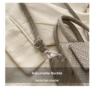 Detail view of the metallic adjustment buckle and woven strap on a summer crossbody bag