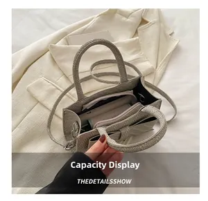 Capacity display of the grey textured handbag with inner compartments and shoulder strap