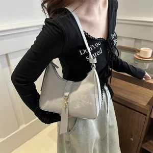 Minimalist silver faux leather hobo bag with metal hook buckle, stylish underarm style