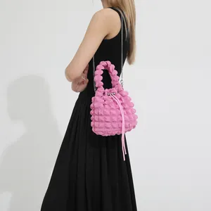 Pink bubble textured bucket bag with silver chain strap and drawstring closure