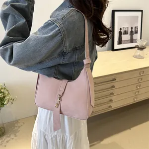 Minimalist light pink hobo underarm bag in a stylish minimalist interior setting