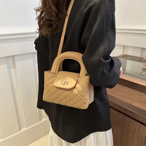 Elegant beige quilted leather crossbody bag with gold twist-lock and circular top handle