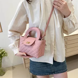 Pink quilted PU leather crossbody bag with top handle and gold turn-lock closure