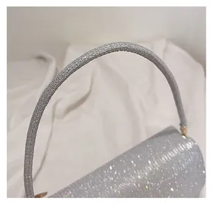Detail of silver sequin handbag shoulder strap and sparkling metallic texture