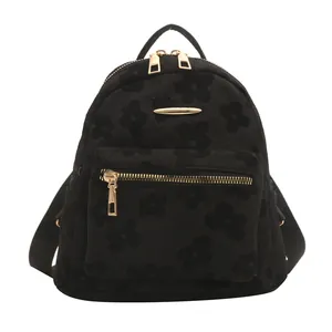 Minimalist black floral mini backpack with 3D floral texture and gold hardware details