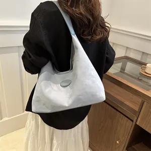 Minimalist light blue soft leather tote bag for women showing large capacity for daily commute