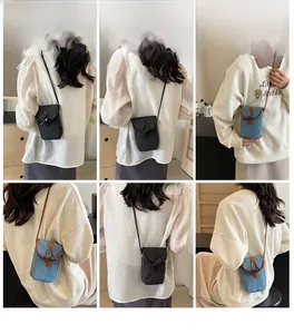 Crossbody phone bag detail showing denim and tweed textures with stylish horn buttons