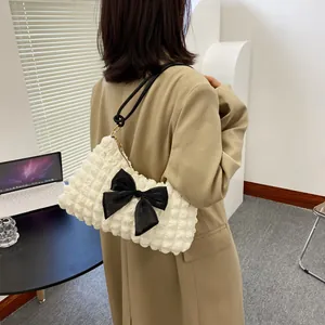 White puffer cloud shoulder bag with large black bow and bubble texture design