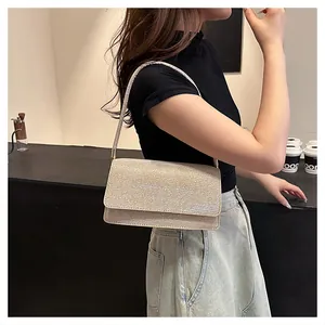 Champagne gold sequin shoulder bag shown on model in a modern urban lifestyle setting