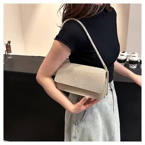 Detail of champagne gold glitter crossbody bag showing sparkly texture and chic flap design