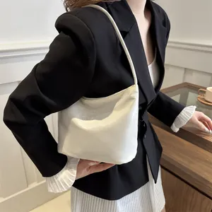 Minimalist white faux leather shoulder bag with elegant 'Onwards and upwards' embroidery