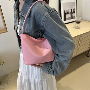 Pink minimalist underarm tote bag with onwards and upwards embroidery on nylon surface