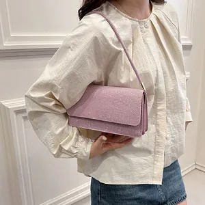Chic purple glitter PU shoulder bag with long strap shown on model for daily style